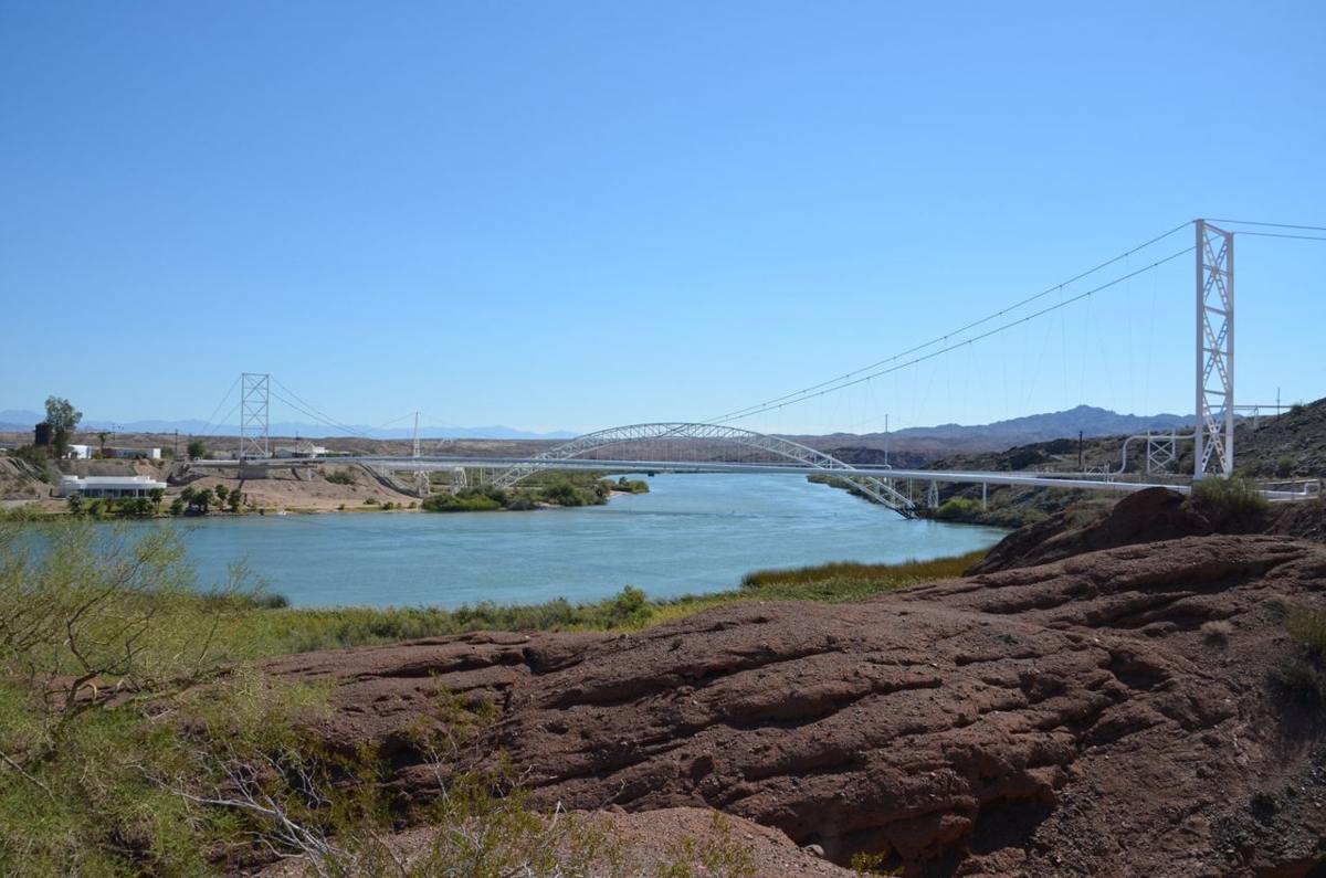 From a rocky knoll, the Colorado River gently flows downstream with the magnificent Trails Arch Bridge in the background. The River forms the natural boundary separating Arizona and California. Once on the
California side, Route 66 travelers could rest and prepare themselves for an incredible and dangerous journey. Looking forward a once-in-a-lifetime adventure on Route 66 across the desolate but beautiful Mojave Desert.
Looking back, the graceful, refreshing waters of the Colorado River.