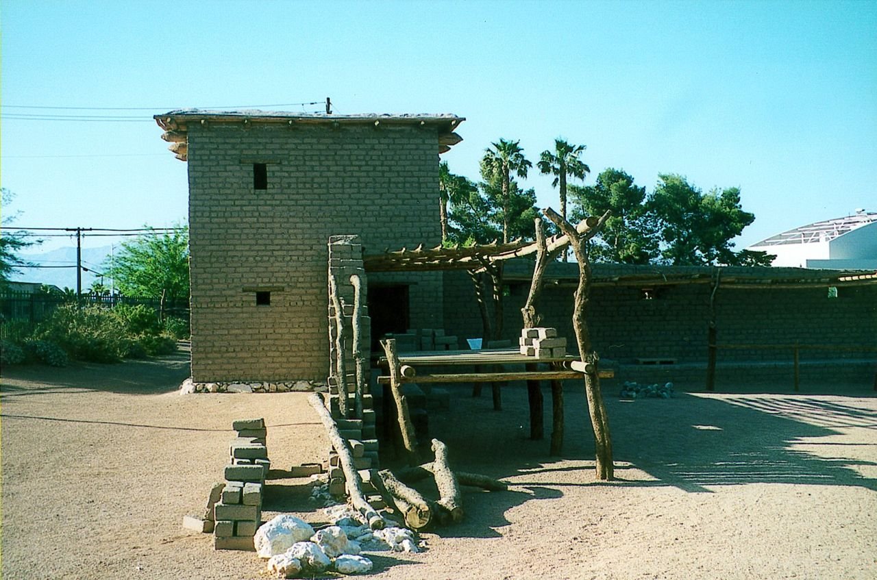 A bright blue sky overlooks the palm trees in the distance at the site of Mormon Fort. This is a re-created section of the 1850s original settlement that would later become the Las Vegas townsite. The Fort is now a State of Nevada Park.