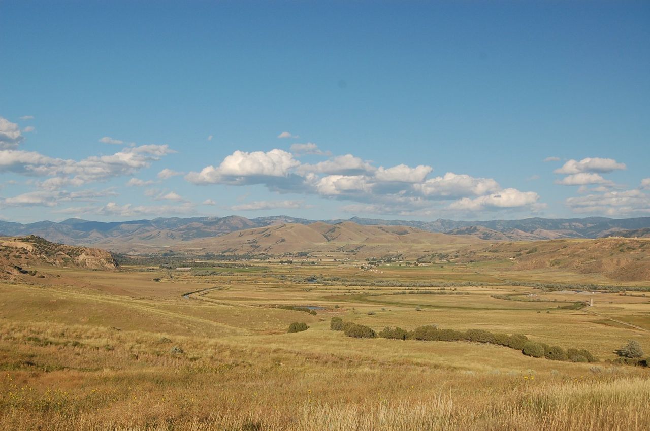 The long valley of the Bear River stretches east toward the mountains, as seen from the upper parking area of the Bear River Massacre National Historic Site.