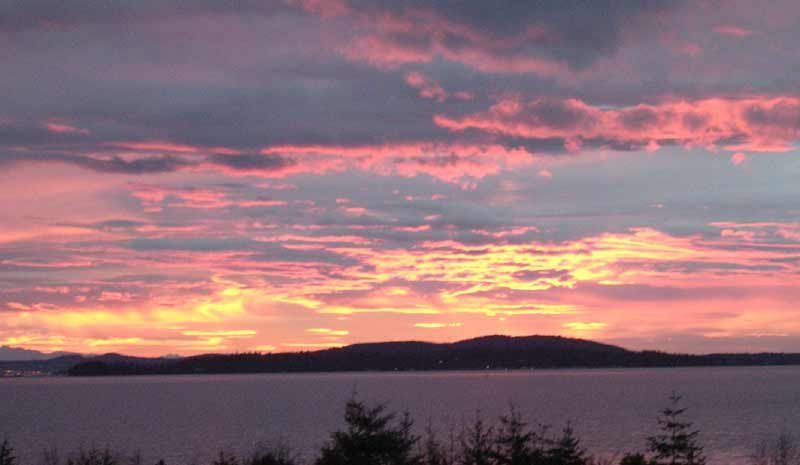 Clouds tinted with pink and gold are a common sight for visitors at Chuckanut Drive.